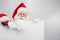 Santa Claus points to an empty white space. Promotional offer for Christmas.