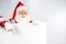 Santa Claus points to an empty white space. Promotional offer for Christmas.