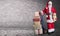 Santa Claus with presents stacked on a delivery trolley in a industrial warehouse theme and background