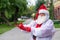 Santa claus in a protective costume puts on gloves.