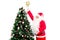 Santa Claus reaching hand up to the top of a Christmas tree for decorating Christmas tree with a star, Merry Christmas happy