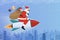 Santa Claus riding a rocket and carrying Christmas gifts