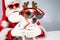 Santa claus and santa's helper in sunglasses on a white background. Jack russell terrier dog in a deer costume