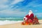 Santa Claus at sea beach with many gifts and decorated christmas