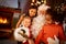 Santa Claus sharing smart phone with children