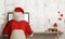 Santa Claus shopping on computer. Christmas sale time. Free space for text