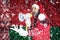 Santa Claus shouts into a megaphone and shows a hand gesture against the background of the flag of Belarus