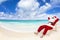 Santa Claus sitting on beach chairs. Christmas holiday concept.