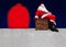 Santa Claus sitting on the chimney at a snowy roof