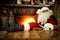 Santa Claus sitting in old gold throne chair and thinking. Wooden table top with blurred fireplace background.