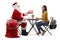 Santa Claus sitting at a table and giving a christmas present to a female student