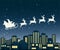 Santa Claus on sledge flies over a city at night.