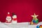 Santa claus, snowman wool doll, green sled on snow set up with g