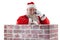 Santa claus standing beside chimney and talking on mobile phone