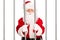 Santa Claus standing in a jail cell