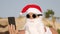 Santa Claus takes selfie. Santa summer vacation. Santa Claus blogger. Funny Santa, in sunglasses, takes selfie video on