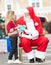 Santa Claus Taking Letter From Girl