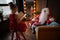 Santa Claus talking with a girl with a large white beard