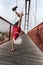 Santa Claus training handstand at one only hand on a bridge in f