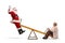 Santa Claus waving and playing on a seesaw with a happy senior woman