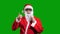 Santa Claus wearing black paper sunglasses on stick over green chroma key background