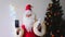 Santa claus with a white beard congratulates children and adults, holds a phone with a blank black screen in his hand, concept of