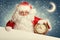 Santa Claus with white blank banner holding a clock