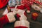 Santa Claus with white gloves holding an envelope at his wooden table with gifts