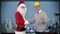 Santa Claus and Young Architect in a modern office, shaking hands and looking at camera, stock footage