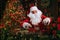 Santa Clause carefully is packing gifts while sitting at the table near Christmas tree. New Year concept