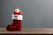 Santa clause doll stand in red sock festive ornaments Merry Christmas
