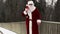 Santa Clause with gift bag and baseball bat on the bridge