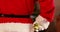 Santa clause holding a gift box behind his back