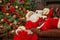 Santa Clause snoozing in a decorated living room with sack full
