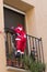 Santa climbing into a house