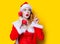 Santa Clous girl in red clothes with handset