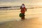 Santa copy space. Holiday greeting card. Santa on sunset beach. Christmas and vacation.