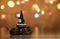 Santa and dog stand near Christmas tree with pine cone and Christmas light background