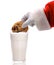 Santa Dunking Cookie into a glass of milk