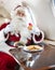 Santa Eating Cookies While Holding Milk Glass In