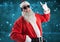 Santa gesturing while listening music on headphones