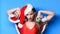 Santa girl with make up. Girl red swimsuit and santa hat hold christmas ball decoration. Woman attractive santa