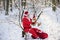 Santa grandfather with Gift and teddy bear read wish list. Santa Claus in Christmas suits in snowy winter mountain. New