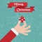 Santa hand with ball. Christmas background with greeting ribbon