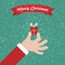 Santa hand with gift. Christmas background with greeting ribbon
