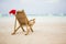 Santa hat on chaise longue on beach