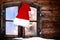 Santa Hat Hanging at Rustic Window Pane