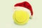 Santa hat on tennis ball Christmas greeting