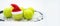 Santa hat on tennis ball, set of tennis balls on racket on white snow winter background. Merry Christmas and New year concept with