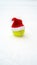 Santa hat on tennis ball on white snow background. Christmas and New year concept with tennis balls. Close up, sport lifestyle